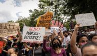 Students and activists gather outside the Commission on Elections to protest its unofficial tally of the national elections, showing presidential candidate Ferdinand 