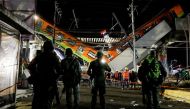 Soldiers stand as rescuers work at a site where an overpass for a metro partially collapsed with train cars on it at Olivos station in Mexico City, Mexico, May 4, 2021. REUTERS/Luis Cortes/File Photo

