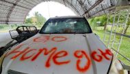 FILE PHOTO: Graffiti written by anti-government factions is pictured on a vehicle, at a house belonging to the former Prime Minister Mahinda Rajapaksa's family, following violent clashes between pro and anti-government factions and police, in Weeraketiya, Sri Lanka, May 11, 2022. REUTERS/Alasdair Pal/File Photo

