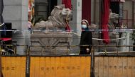 A woman walks on a closed street during lockdown, amid the coronavirus disease (COVID-19) pandemic, in Shanghai, China, May 13, 2022. REUTERS/Aly Song