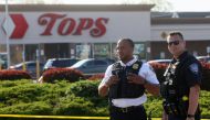 Law-enforcement officers stand guard outside TOPS supermarket following a shooting in Buffalo, New York, U.S. May 15, 2022. Reuters/Brendan McDermid
