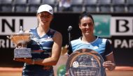 Poland's Iga Swiatek poses with the trophy after winning the Italian Open, alongside runner up Tunisia's Ons Jabeur Reuters/Guglielmo Mangiapane
