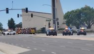 Emergency personnel respond at the scene of a shooting outside a church in Laguna Woods, California, U.S., in this still image from a social media video, May 15, 2022. Courtesy of Alana Geiger/ via REUTERS