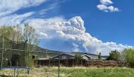 Smoke rising from the Calf Creek Hermits Peak fire burning forests and watershed below Jicarita Peak in the Pecos Wilderness is seen from Taos, New Mexico, U.S., May 15, 2022. Picture taken May 15, 2022. REUTERS/Andrew Hay
