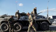 FILE PHOTO: Service members of pro-Russian troops wait before the expected evacuation of wounded Ukrainian soldiers from the besieged Azovstal steel mill in the course of Ukraine-Russia conflict in Mariupol, Ukraine May 16, 2022. REUTERS/Alexander Ermochenko