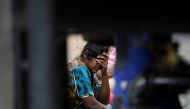 A woman reacts as she waits in a queue to buy kerosene at a fuel station, amid the country's economic crisis in Colombo, Sri Lanka, May 18, 2022. REUTERS/Adnan Abidi