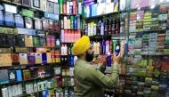 A shopkeeper arranges spray perfumes in a showcase at his shop in Peshawar, Pakistan, May 19, 2022. REUTERS/Fayaz Aziz
