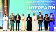 Minister of State for Foreign Affairs H E Sultan bin Saad Al Muraikhi and Chairman of the Board of Directors of Doha International Center for Interfaith Dialogue (DICID), Dr. Ibrahim bin Saleh Al Nuaimi with winners of Doha International Award for Interfaith Dialogue 2022. PIC: Abdul Basit