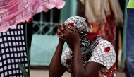 Kaba, a mother of a ten-day-old baby, reacts as she sits outside the hospital, where newborn babies died in a fire at the neonatal section of a regional hospital in Tivaouane, senegal, May 26, 2022. Reuters/Zohra Bensemra
