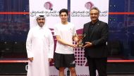 Salem Al Malki with the Qatar Tennis, Squash and Badminton Federation Secretary-General Tariq Zainal during the presentation ceremony.