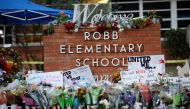 Flowers, candles and signs are left at a memorial for victims of the Robb Elementary school shooting, three days after a gunman killed nineteen children and two teachers, in Uvalde, Texas, U.S. May 27, 2022. REUTERS/Marco Bello