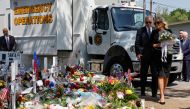US President Joe Biden and first lady Jill Biden, who holds a bouquet of 21 white flowers, pay their respects at a memorial at Robb Elementary School, in Uvalde, Texas, U.S. May 29, 2022. Reuters/Jonathan Ernst
