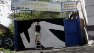 Ukrainian artist Gamlet Zinkivskiy works on his new painting, amid Russia's attack on Ukraine, in Kharkiv, Ukraine, May 13, 2022. Reuters/Ricardo Moraes