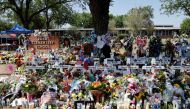 Tributes are seen at a memorial at Robb Elementary School, where a gunman killed 19 children and two teachers in the deadliest U.S. school shooting in nearly a decade, in Uvalde, Texas, U.S. May 29, 2022. REUTERS/Jonathan Ernst

