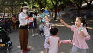 Children play with bubbles at a park during Dragon Boat festival holiday, following the coronavirus disease (COVID-19) outbreak, in Beijing, China June 4, 2022. Reuters/Tingshu Wang