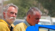 Jim Fitton from Britain and Volker Waldmann from Germany outside a court in Baghdad, Iraq, May 22, 2022. Reuters/Thaier Al-Sudani/File Photo
