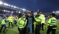 Police officer detain Everton fans as they celebrate avoiding relegation from the Premier League during a pitch invasion after the match Action Images via Reuters/Carl Recine


