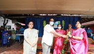 A sapling being handed over to mark the initiative.