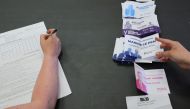 An official counts ballots for the first round of French parliamentary elections, at a polling station in Henin-Beaumont, France, June 12, 2022. Reuters/Pascal Rossignol