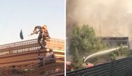 A Taliban Special Forces climbing a nearby building in Kabul, Afghanistan June 18, 2022 (left) and firefighters try to hose down a fire at a building in Kabul, Afghanistan. Both the images obtained by Reuters from a social media video via Reuters.
