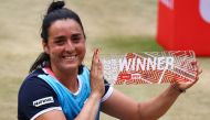 Tunisia's Ons Jabeur celebrates with the trophy after winning her final match against Switzerland's Belinda Bencic REUTERS/Christian Mang
