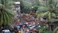 Rescue workers remove debris from the site of a collapsed residential building in Mumbai, India, June 28, 2022. REUTERS/Niharika Kulkarni