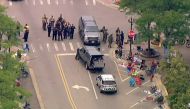 Police deploy after gunfire erupted at a Fourth of July parade route in the wealthy Chicago suburb of Highland Park, Illinois, US, on July 4, 2022 in a still image from video. (Reuters)