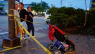 Community members visit the the site of a mass shooting at a Fourth of July parade route in the Chicago suburb of Highland Park, Illinois, U.S. July 4, 2022. REUTERS/Cheney Orr