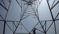 A worker of Peshawar Electric Supply Company (PESCO) climbs up a high-voltage pylon in Peshawar, Pakistan, August 7, 2017. (Reuters/Fayaz Aziz/File Photo)