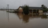 A home is inundated by floodwaters, following heavy rains and severe flooding in the McGraths Hill suburb of Sydney, Australia, July 6, 2022. REUTERS/Loren Elliott