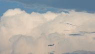 A plane flies with the rain clouds in the background, during the monsoon season in Karachi, Pakistan, July 6, 2022. (Reuters/Akhtar Soomro)

