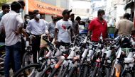 Customers wait outside a cycle shop to buy brand new cycles due to major fuel shortage, amid the country's economic crisis, in Colombo, Sri lanka, July 6, 2022. (Reuters/Dinuka Liyanawatte)