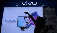 A man cleans a screen displaying a phone model of Chinese smartphone maker Vivo inside a shop in Ahmedabad, India, on December 14, 2018. (Reuters/Amit Dave)

