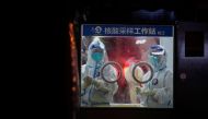 Medical workers in protective suits stand at a nucleic acid testing site in Shanghai, China July 7, 2022. REUTERS/Aly Song