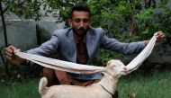 Simba, one month and four days old kid goat with 22-inch long ears, is held by his owner in Karachi, Pakistan July 8, 2022. REUTERS/Akhtar Soomro