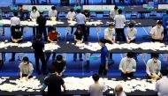 Election officials count votes at a ballot counting centre for Japan's upper house election in Tokyo, Japan, July 10, 2022. (REUTERS/Issei Kato)