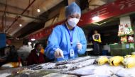 A staff member of Nanming district's Center for Disease Control and Prevention collects a swab from frozen fish for nucleic acid testing following the coronavirus disease (COVID-19) outbreak, at Wandong market in Guiyang, Guizhou province, China July 1, 2020. Picture taken July 1, 2020. cnsphoto via REUTERS
