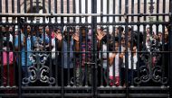 People wait behind a gate to visit the President's house on the day after demonstrators entered the building, after President Gotabaya Rajapaksa fled, amid the country's economic crisis, in Colombo, Sri Lanka July 10, 2022. REUTERS/Dinuka Liyanawatte