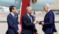 Israeli President Isaac Herzog looks on as Prime Minister Yair Lapid bumps fists with US President Joe Biden during a welcoming ceremony at Ben Gurion International Airport in Lod, near Tel Aviv, Israel, July 13, 2022. (REUTERS/Amir Cohen) 