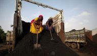 Workers unload coal from a supply truck at a yard on the outskirts of Ahmedabad, India October 12, 2021. REUTERS/Amit Dave

