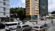 Venezuelan professional breakdance athlete Kenyer Mendez, 27, who has gone viral by performing a head slide trick to make a living dancing at Colombia's traffic lights and dreams of joining Venezuela's first Olympic breakdance team in 2024, performs at a traffic light, in Caracas, Venezuela, recently. (REUTERS/Gaby Oraa)