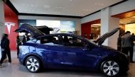 Visitors wearing face masks check a China-made Tesla Model Y sport utility vehicle (SUV) at the electric vehicle maker's showroom in Beijing, China January 5, 2021. REUTERS/Tingshu Wang/File Photo/File Photo