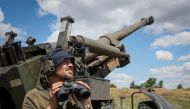 A Ukrainian service member checks an area after a shooting from a towed howitzer FH-70 at a front line, as Russia's attack on Ukraine continues, in Donbas Region, Ukraine, July 18, 2022. (REUTERS/Gleb Garanich)