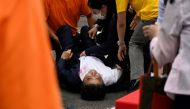 FILE PHOTO: Former Japanese Prime Minister Shinzo Abe lies on the ground after he was shot during an election campaign in Nara, western Japan July 8, 2022 in this photo taken by The Asahi Shimbun. Image pixelated at source. The Asahi Shimbun/via REUTERS ATTENTION EDITORS - THIS IMAGE WAS PROVIDED BY A THIRD PARTY. MANDATORY CREDIT. NO RESALES. NO ARCHIVES. JAPAN OUT. NO COMMERCIAL OR EDITORIAL SALES IN JAPAN./File Photo