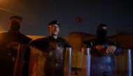 Police officers stand in front of a building belonging to the Turkish Embassy during a demonstration against an alleged Turkish attack on a mountain resort in Iraq's northern province of Dohuk, in Baghdad, Iraq July 20, 2022. (REUTERS/Ahmed Saad)