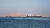 A container ship passes by a beach in the Aqaba Gulf in front of Tiran island which transferred into Saudi Arabia in 2017 off the Red Sea resort of Sharm el-Sheikh, Egypt July 12, 2018. REUTERS/Amr Abdallah Dalsh

