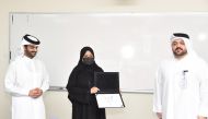 Dr. Saheim Khalaf Al Temimi (right), Director of the Continuing and Professional Education Directorate, giving certificate to a participant.