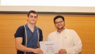 A student receiving the participation certificate. 