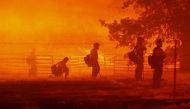 Firefighters look on as the Oak Fire burns in Darrah in Mariposa County, California, July 22.  REUTERS/David Swanson