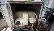 Employees move ice blocks onto a truck to send them to a testing site for the coronavirus disease (COVID-19), at Shanghai Yuhu ice-making factory, amid a heatwave warning in Shanghai, China July 26, 2022. REUTERS/Aly Song